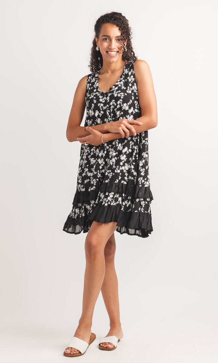 Woman wearing a black and white patterned dress on a white background