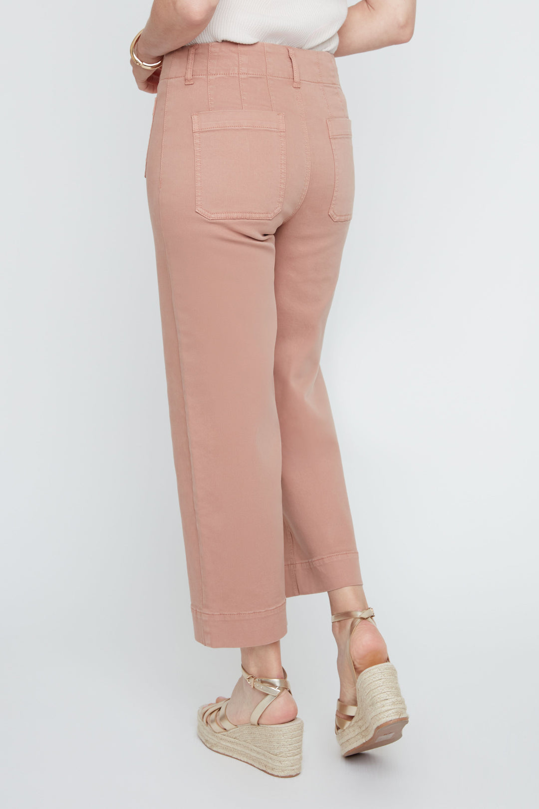 Person wearing pink pants on a white background