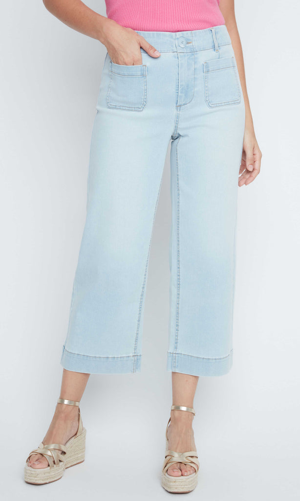Light blue jeans worn by a person on a white background