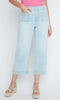 Light blue jeans worn by a person on a white background