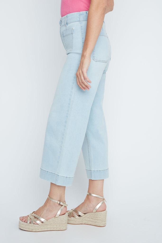 Light blue jeans worn by a person on a white background