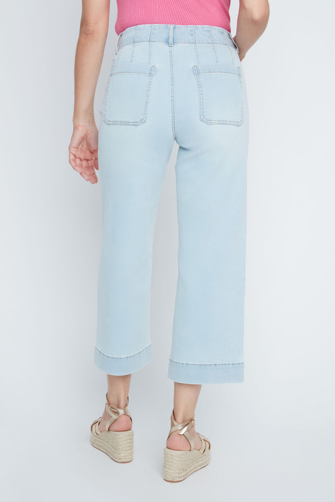 Light blue jeans worn by a person on a white background