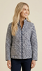Woman wearing a patterned jacket on a beige background