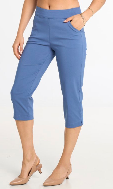 Blue capri pants worn by a person on a white background