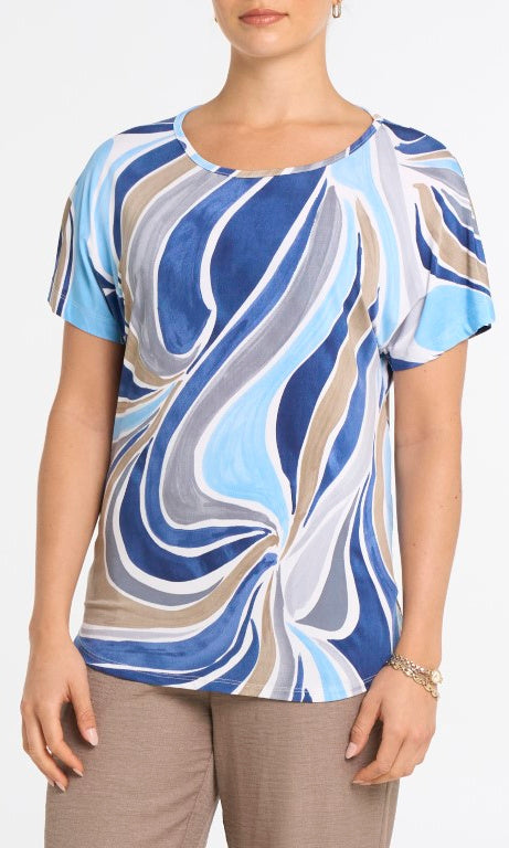 Woman wearing a blue and white patterned top on a plain background