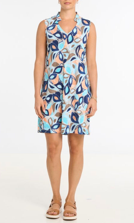 Woman wearing a sleeveless dress with a colorful abstract pattern on a white background
