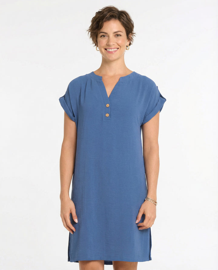 Woman wearing a blue dress with short sleeves on a white background