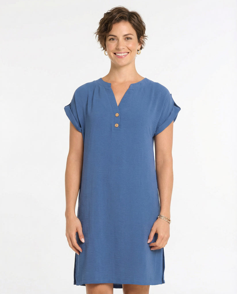Woman wearing a blue dress with short sleeves on a white background