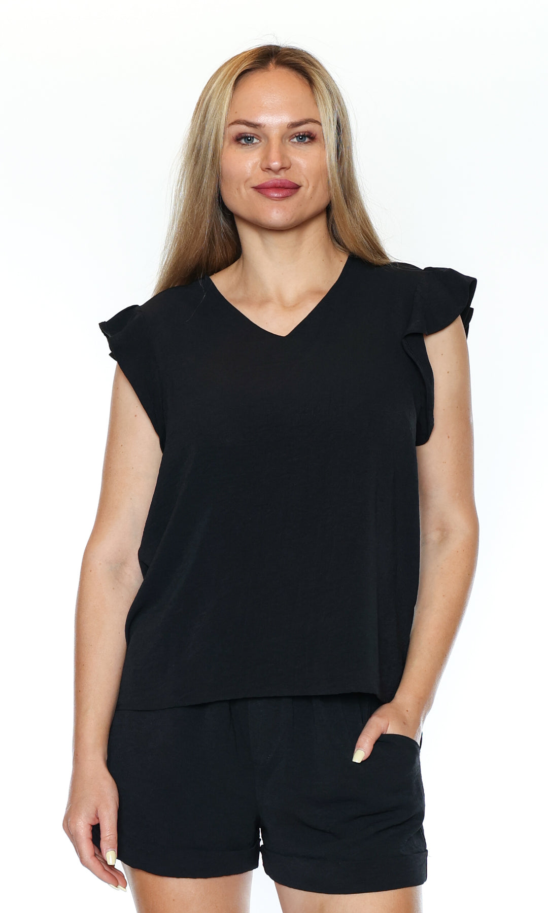 Woman wearing a black top and shorts on a white background