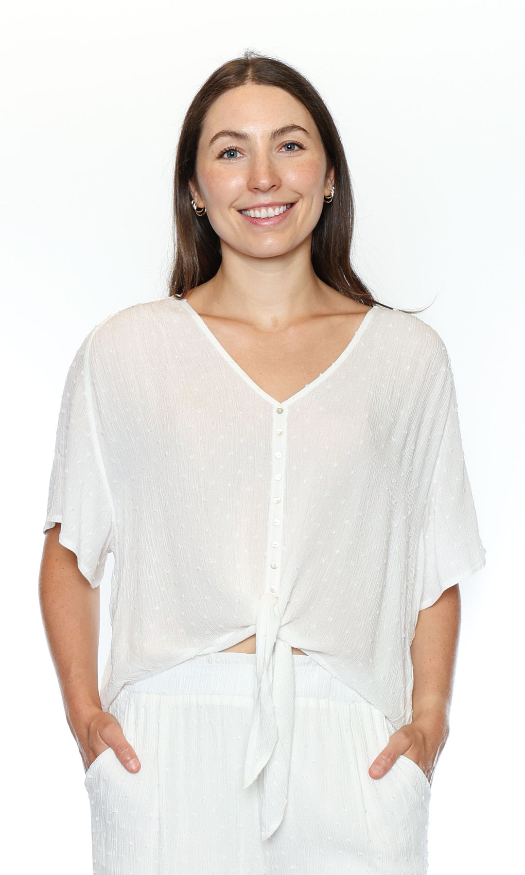 Woman wearing a white blouse with a plain background