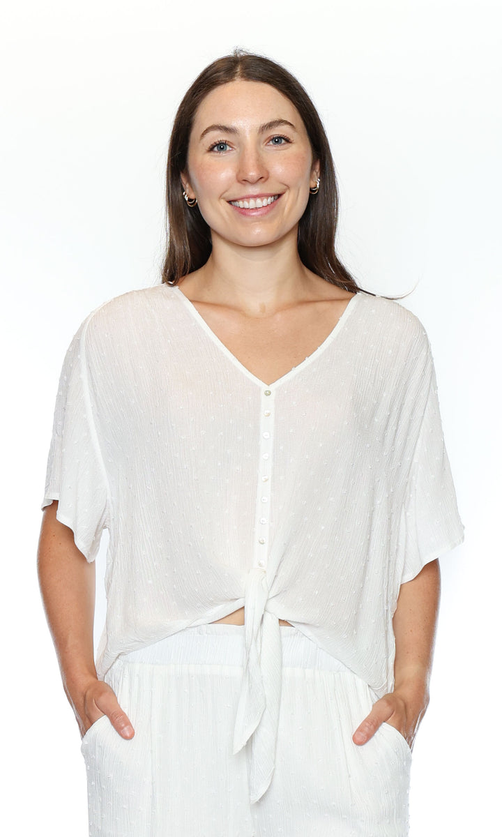 Woman wearing a white blouse with a plain background
