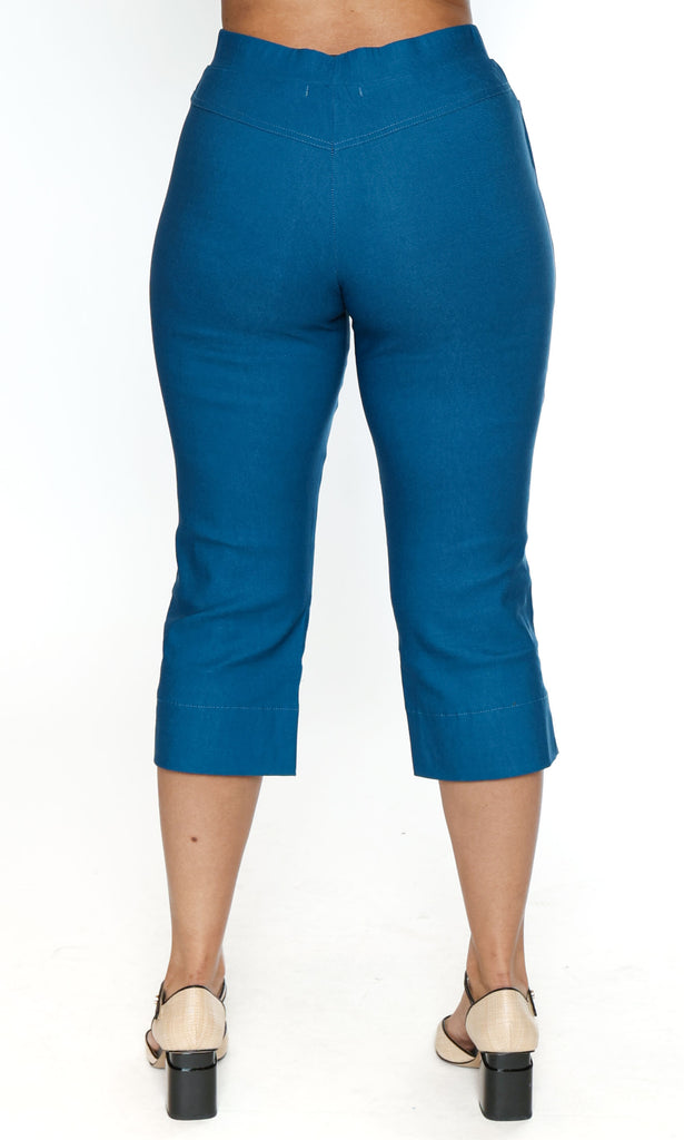 Blue capri pants worn by a person on a white background