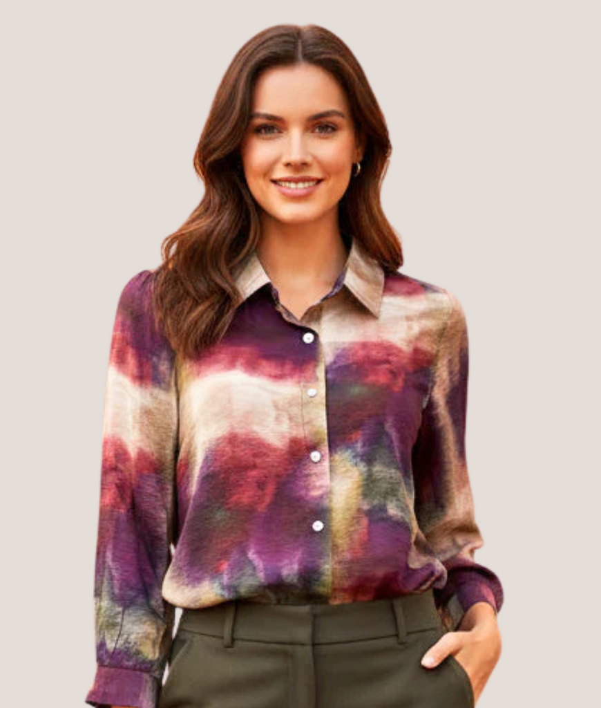 Woman wearing a colorful plaid shirt against a plain background