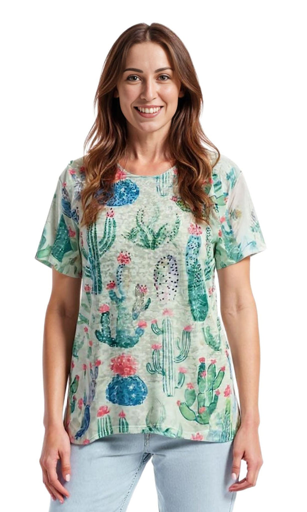 Woman wearing a colorful cactus print shirt on a white background