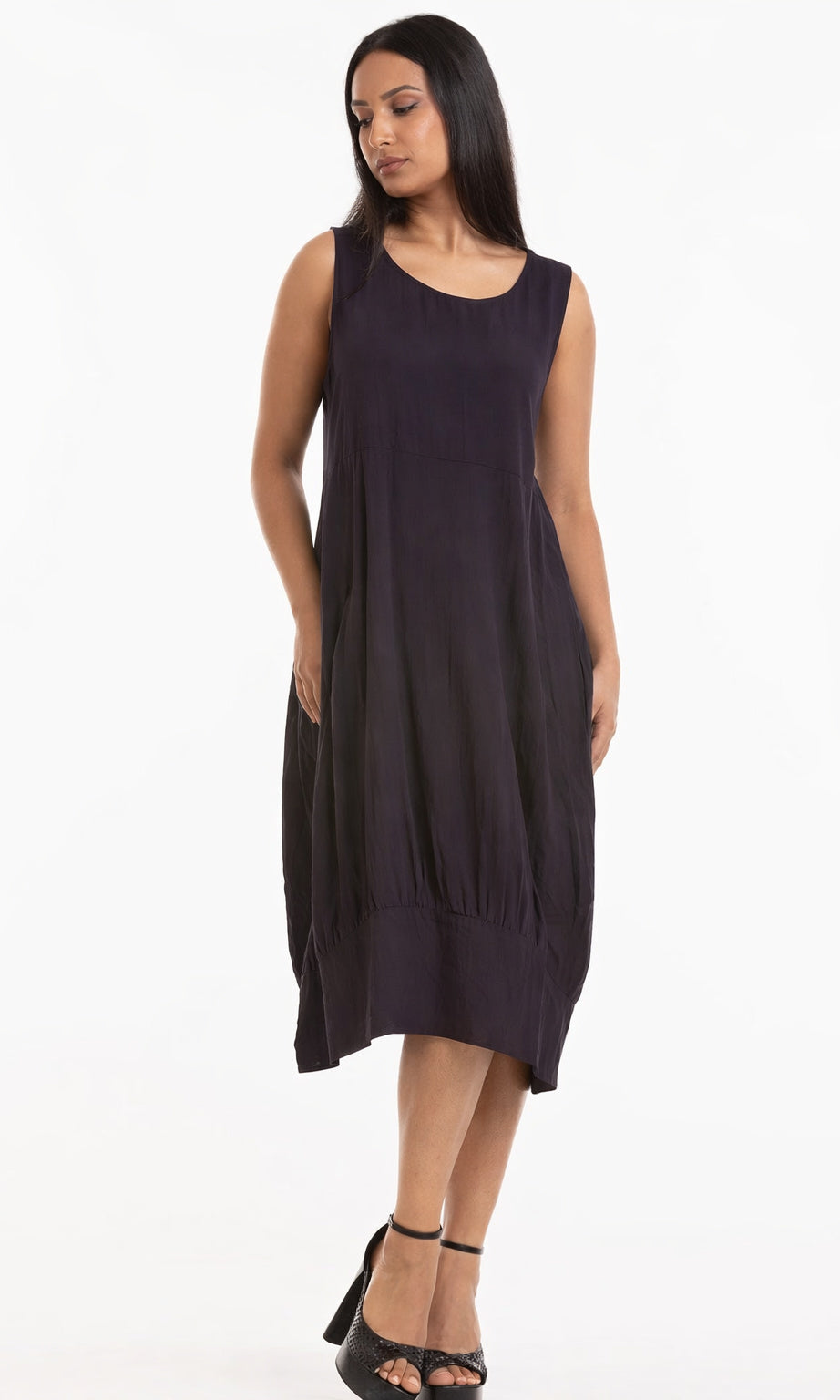 Woman wearing a dark sleeveless dress on a white background