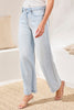 Light blue jeans worn by a person on a neutral background