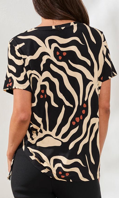 Black t-shirt with beige tiger pattern worn by a person on a white background