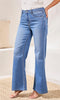 Person wearing blue jeans on a neutral background