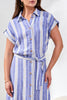Woman wearing a blue and white striped dress with a belt against a white background
