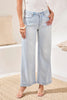 Light blue jeans worn by a person in a minimal indoor setting