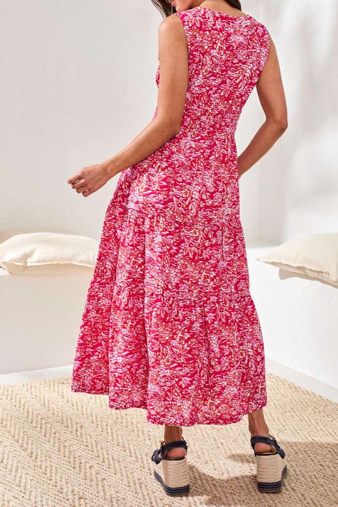 Person wearing a red floral dress in a minimal indoor setting