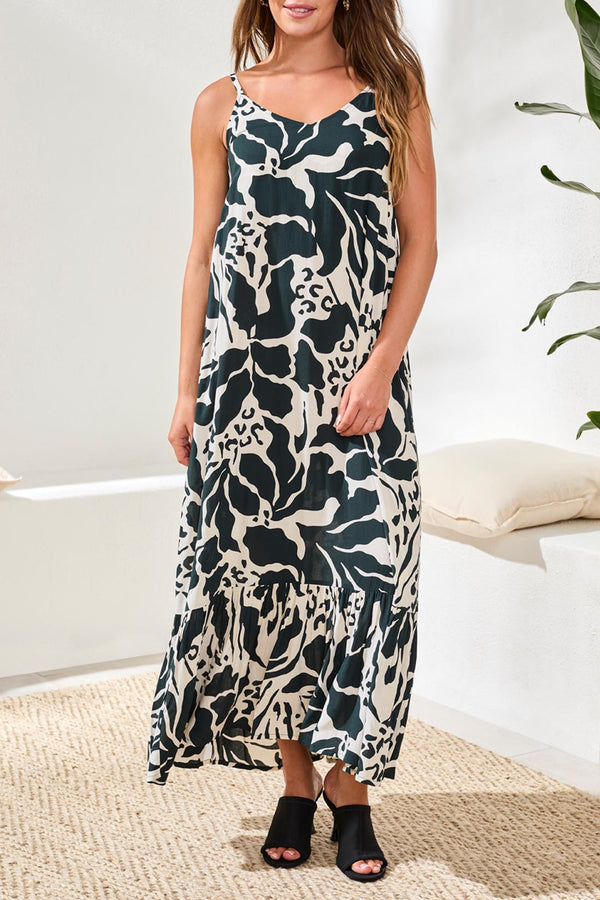 Woman wearing a floral dress in a minimal indoor setting