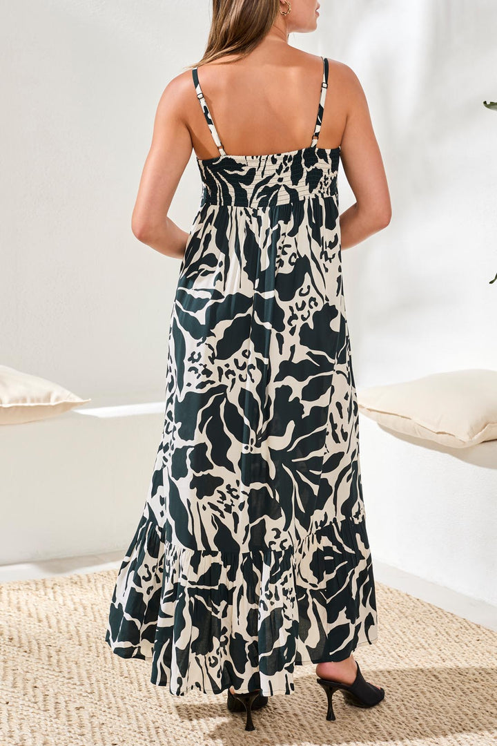 Woman wearing a black and white patterned dress in a minimal indoor setting