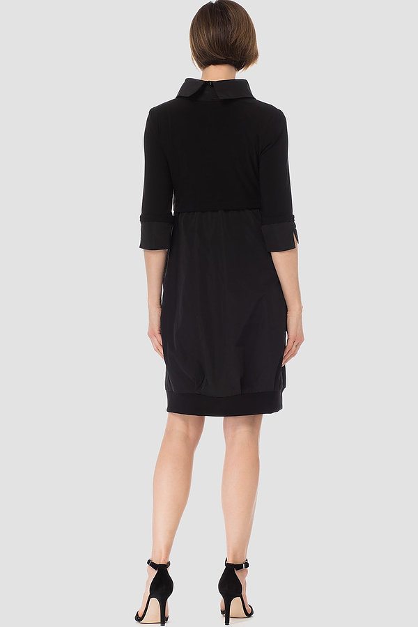The back of a knee-length navy dress with a mock neckline, long cuffed sleeves, and front pockets.